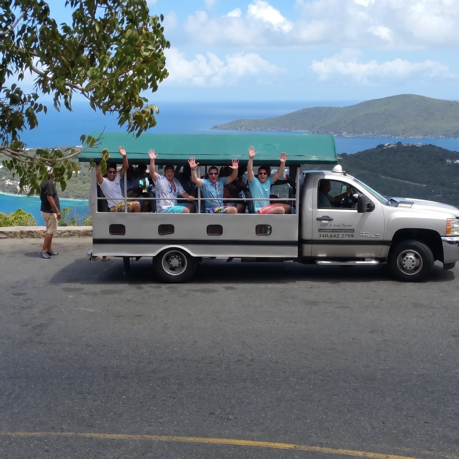 Guests riding the open air safari bus on a St. Thomas island tour